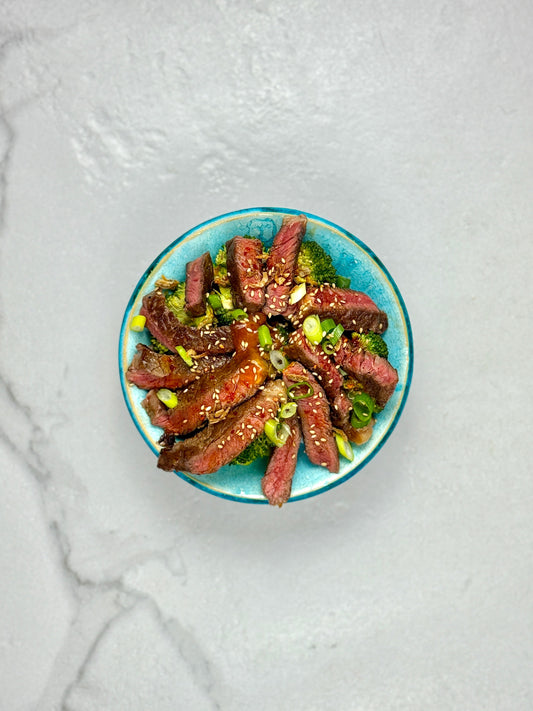 Steak over garlic rice w/ broccoli & beans